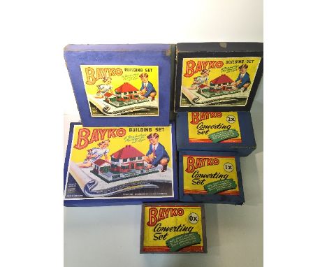 Six Bayko construction sets: No.0, includes instruction booklet; No.0X, parts include green marbled base and small roof no.23