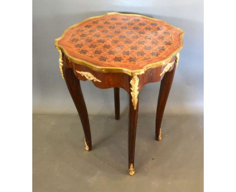 A French inlaid and gilt metal mounted lamp table, the star inlaid shaped top above a shaped frieze raised upon cabriole legs