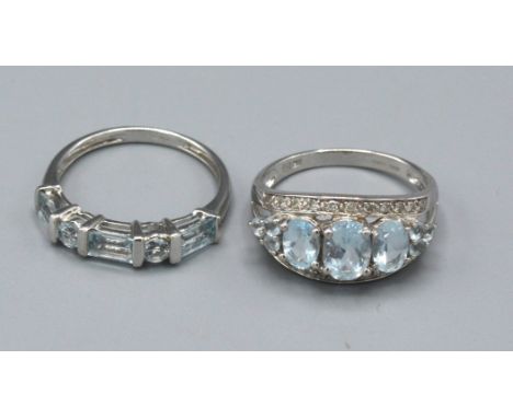 A 9ct. White Gold Aquamarine and Diamond Set Dress Ring, ring size O, 2.9 gms. together with another similar 9ct. gold dress 