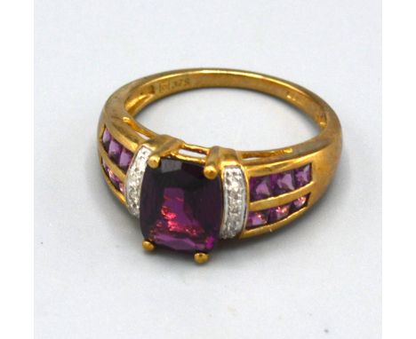 A 9ct. Gold Amethyst and Diamond Set Ring with a central amethyst flanked by diamonds and two bands of amethysts, ring size N