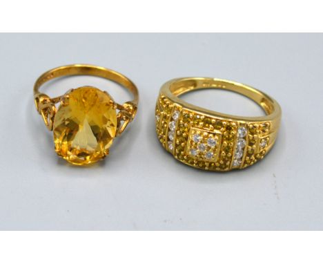 A 9ct. Gold Ring set with an oval citrine, claw set, ring size K, 2.4 gms. together with another similar 9ct. gold dress ring