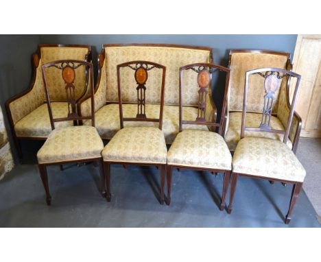 An Edwardian Mahogany Marquetry Inlaid Drawing Room Suite comprising a two seater sofa, a pair of matching armchairs and four