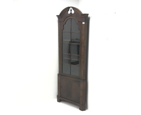  20th century walnut corner cabinet, arched swan neck pediment with central finial, single glazed door, two shelves, cupboard