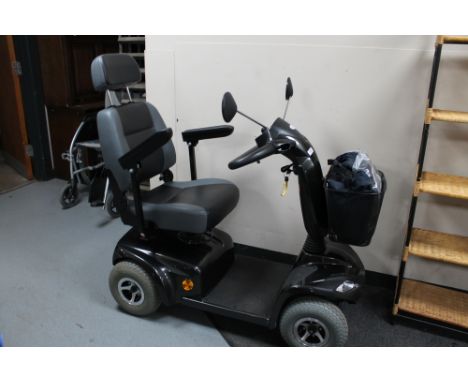 A Strider ST 4E mobility scooter with charger and key 