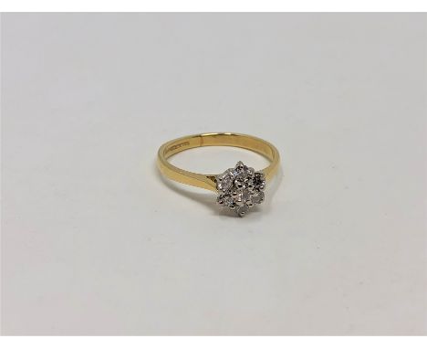 An 18ct gold seven stone diamond cluster ring, size K CONDITION REPORT: 2.3g