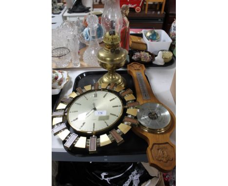 A Metamec quartz wall clock together with a wooden barometer and a lamp 