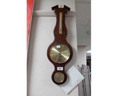 A reproduction oak barometer 