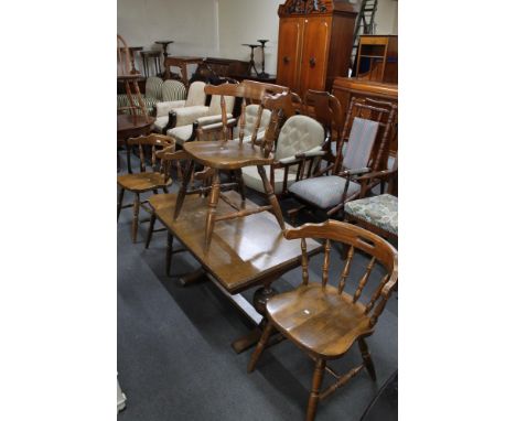 Four light oak kitchen chairs and a light oak coffee table. 