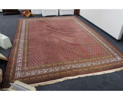 A large machined Persian design carpet  