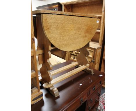 A light oak drop leaf table 