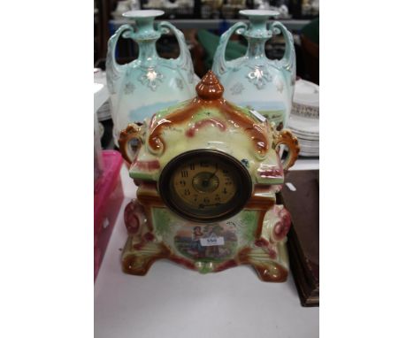 An Edwardian ceramic clock together with a pair of transfer printed vases 