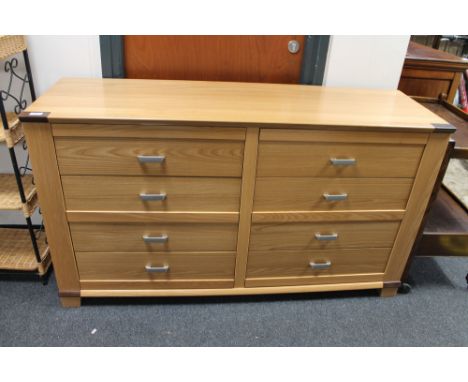 A light beech eight drawer chest 