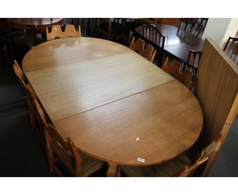 A light oak extending dining room table and six chairs. 