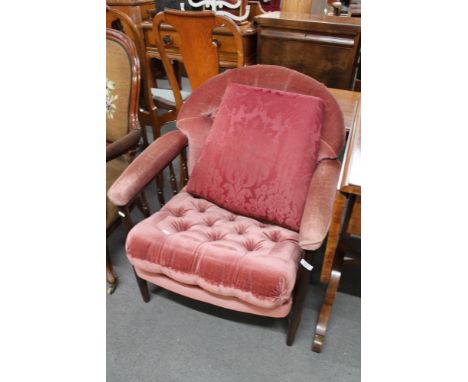 A reproduction armchair in button pink dralon. 