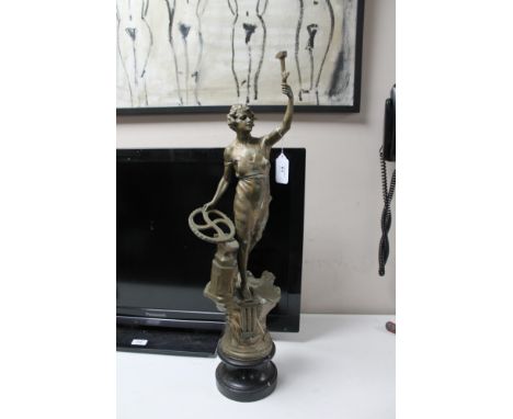 A patinated metal figure of a woman with hammer and anvil, height 69cm