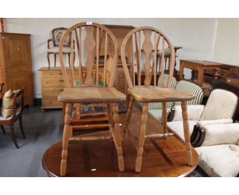 A pair of light oak kitchen chairs. 