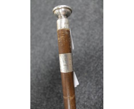 A swagger stick with silver mounts 