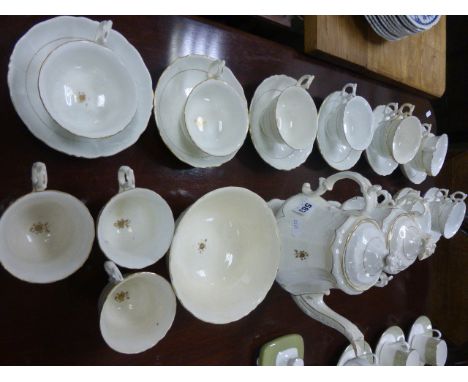 Early 19th century Rockigham Style Tea Service, Cream Ground with Gilt Borders comprising Tea Pot, Two Sugar Bowls, Jug, Elev