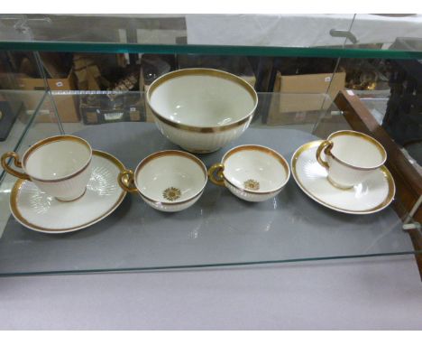 Group of Swansea Porcelain, cream body and gilt decoration including Slop Bowl, Two Cups and Saucers and Two Squat Tea Cups
