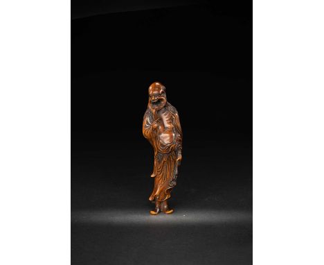 A LARGE JAPANESE WOOD NETSUKE OF A SENNINEDO PERIOD, 18TH CENTURYThe tall emaciated Immortal turning his head to the side wit