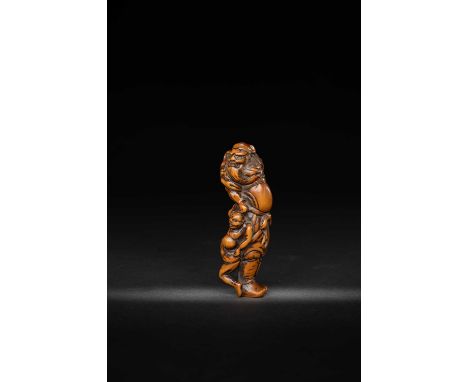 A JAPANESE WOOD NETSUKE OF SHOKI AND AN ONIEDO PERIOD, 18TH/19TH CENTURYThe Demon Queller depicted standing, turning to the r