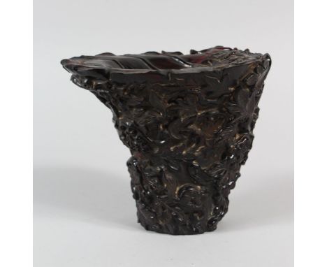 A CHINESE CARVED HORN / HORN STYLE LIBATION CUP, decorated with fruiting, vines and squirrels, seal mark to the base, 13.5cm 