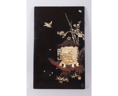 A JAPANESE MEIJI PERIOD WOOD &amp; SHIBAYAMA PANEL, the panel decorated in high relief with carved ivory and wood to depict t