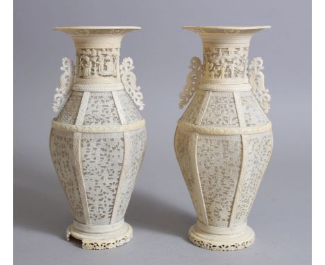 A PAIR OF 19TH CENTURY CHINESE CANTONESE CARVED &amp; PIERCED IVORY VASES, carved and pierced sections with scenes of figures