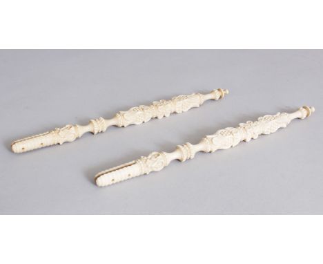 A PAIR OF ORIENTAL CARVED IVORY FAN HANDLES. 20.1cm long.