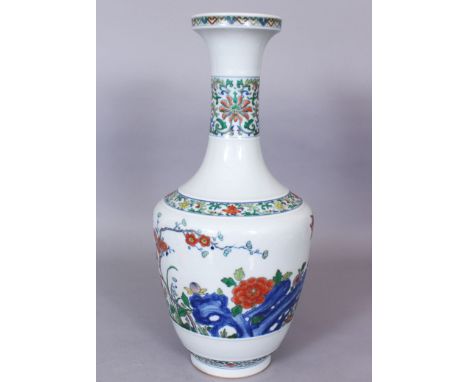 A CHINESE DOUCAI PORCELAIN VASE, the sides decorated with a garden scene of butterflies, flowers, blossoming boughs and rockw