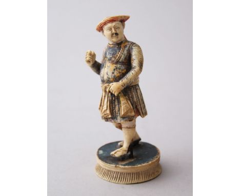 A 19TH CENTURY CARVED IVORY GAME PIECE FIGURE, stood in a waling pose with his let foot aloft, wearing a mughal costume and a