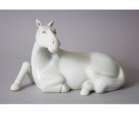 A ORIENTAL WHITE GLAZED PORCELAIN MODEL OF A RECUMBENT HORSE, possilby Hirado, 20th century, 10.5cm high x 17.5cm wide.