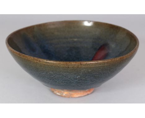 A CHINESE JUN WARE PURPLE SPLASH CERAMIC BOWL, the glaze falling short of the foot, 19.3cm diameter  &amp; 8.1cm high.