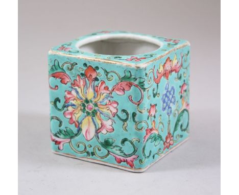 A CHINESE MARK AND PERIOD TURQUOISE GROUND FAMILLE ROSE BRUSH POT, decorated with formal flora and scroll decoration, the bas