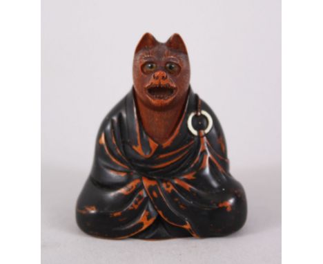 A JAPANESE EDO PERIOD BOXWOOD NETSUKE OF A FOX DISGUISED AS A PRIEST, in a seated position with his mouth open and wearing a 
