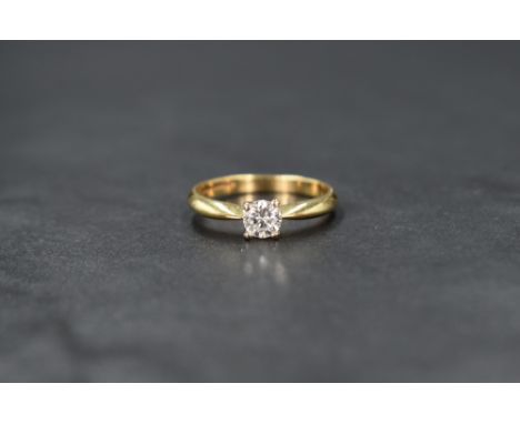 An 18ct gold diamond solitaire ring, the round brilliant cut diamond measuring approximately 0.37ct, in a four claw setting, 