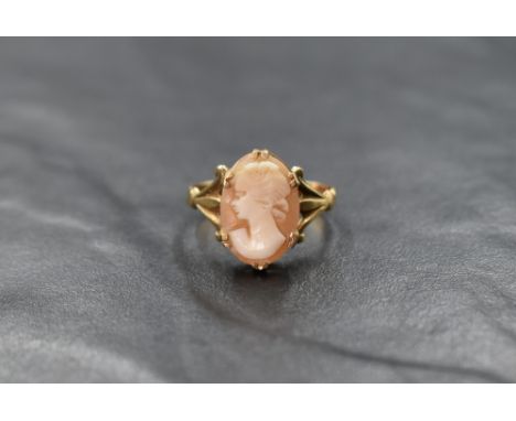 A 9ct gold cameo ring depicting a maiden in profile panel in claw set mount to split shoulders, size R &amp; approx 2.9g