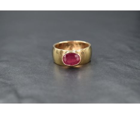 A gent's 9ct gold band ring having added oval ruby in a collared mount, approx 1.5ct, size V &amp; approx 11g