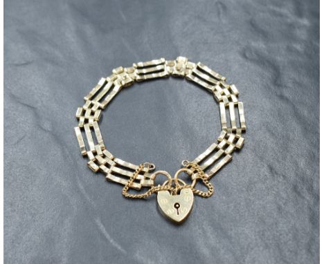A 9ct gold three bar gate bracelet having padlock clasp, approx 190mm long &amp; 8.5g