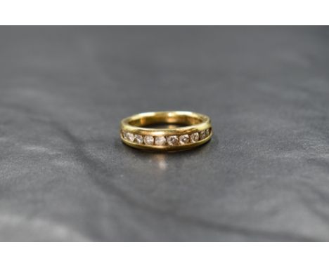 An 18ct gold half eternity ring having ten small brilliant cut diamonds in a channel setting, total approx 0.50ct, on an 18ct