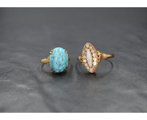 A 9ct gold opal and cubic zirconia cluster ring, the marquise cut opal with a cubic zirconia surround and decorative shoulder