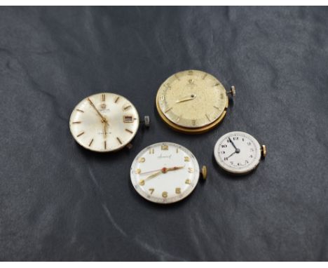 Four assorted wrist watch mechanisms including two Omega, an Accurist and an unmarked lady's model.