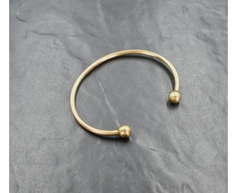 A 9ct gold torque bangle of plain form, internal diameter approx 72mm &amp; 24.5g