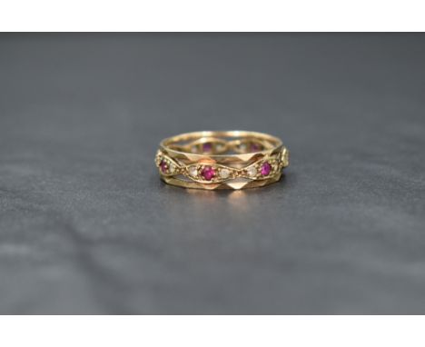 A 9ct gold eternity ring having ruby and cubic zirconia stones in an open setting, one ruby missing, size T &amp; approx 3.4g