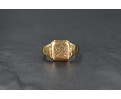 A gent's 9ct gold signet ring having worn engraving to cartouche and engraved inscription en verso, size V &amp; approx 4.5g