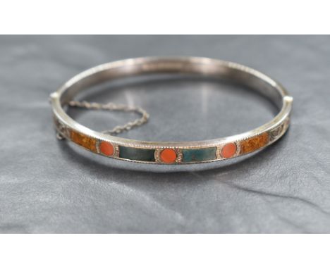 A Scottish silver hinged bangle having mixed agate panelled decoration to one half, Birmingham hallmarks but maker  for Camer