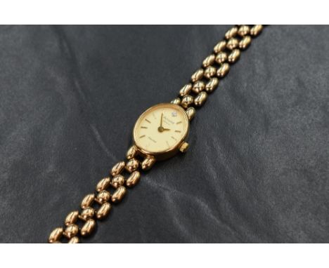 A 9ct gold Accurist wristwatch, the oval champagne dial having baton numerals, on a 9ct gold bracelet strap, 17.4g. In origin