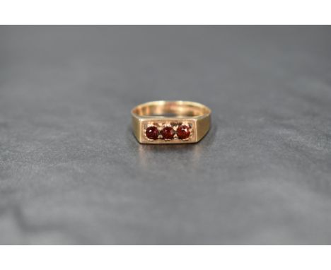 A 9ct gold garnet trilogy ring having a claw set mount in a box style setting, size N &amp; approx 2.4g