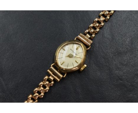 A 9ct gold Accurist wristwatch, the marquise champagne dial having baton numerals, on a 9ct gold bracelet strap, 9.3g