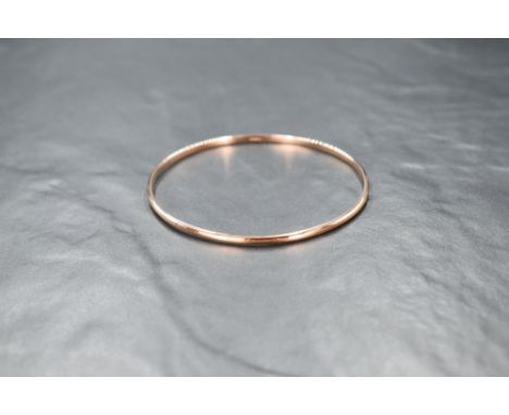 A 9ct rose gold slave bangle of plain form, inner diameter approx 65mm &amp; approx 8.7g